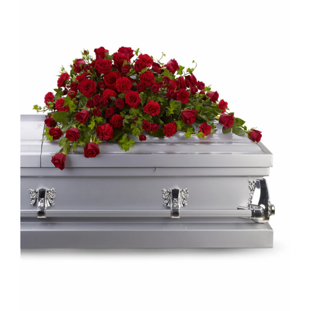 Red rose arrangement on a casket, symbolizing reverence.